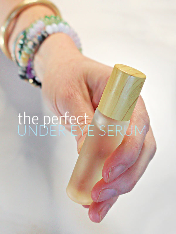 Hand holding a glass roll on bottle with DIY Castor Oil Eye Serum